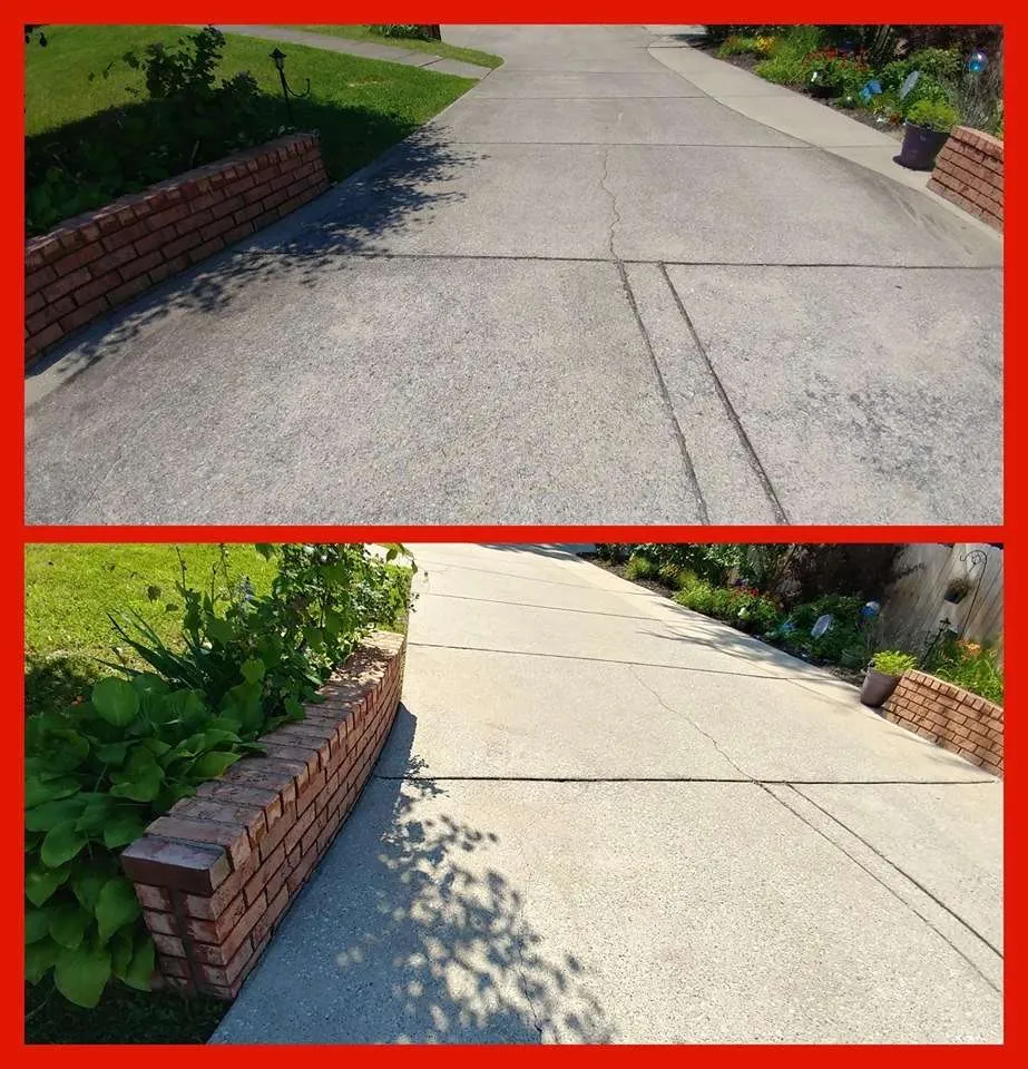 A concrete driveway being cleaned.