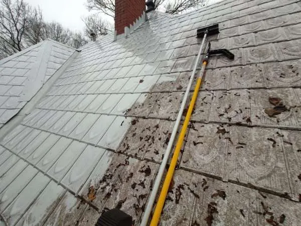A side-by-side comparison of a roof being cleaned with the soft wash method.