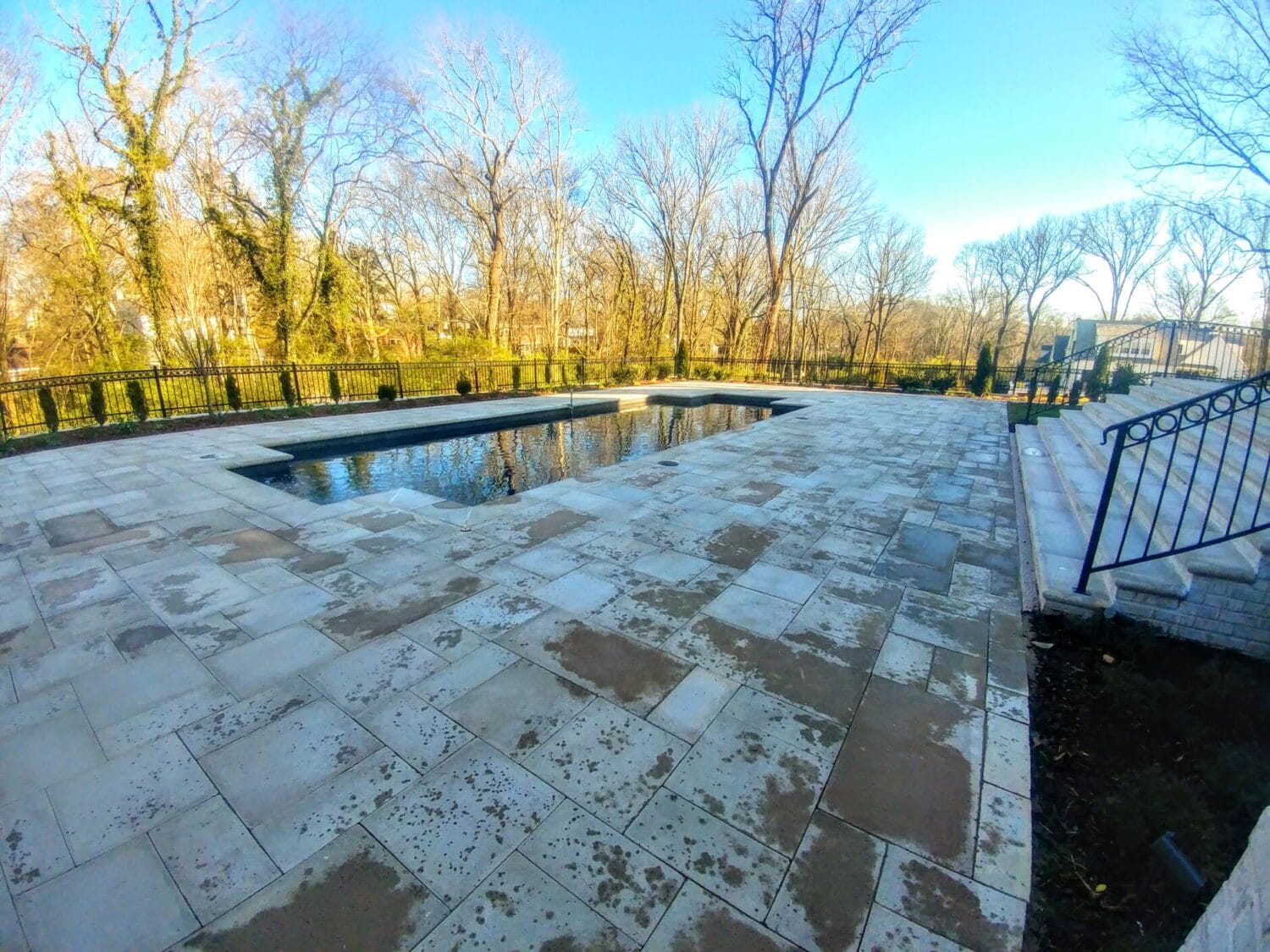 A clean and pristine travertine pool patio.
