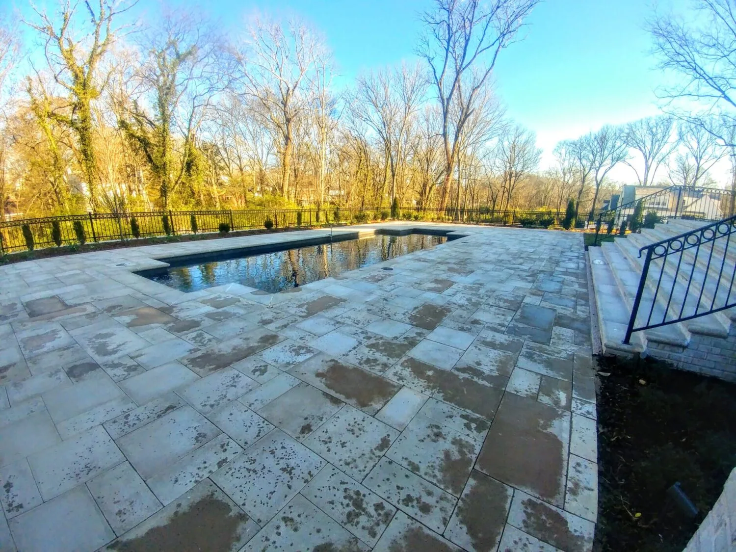 A clean and pristine travertine pool patio.