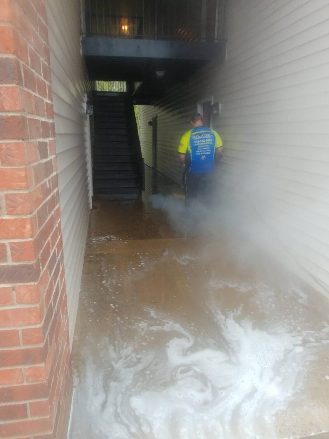 Breezeway concrete property management cleaning before and after at a Nashville apartment complex.