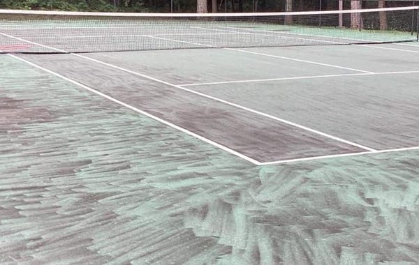 Wand marks left across a Nashville tennis court by high pressure cleaning, the damage correct tennis court cleaning avoids